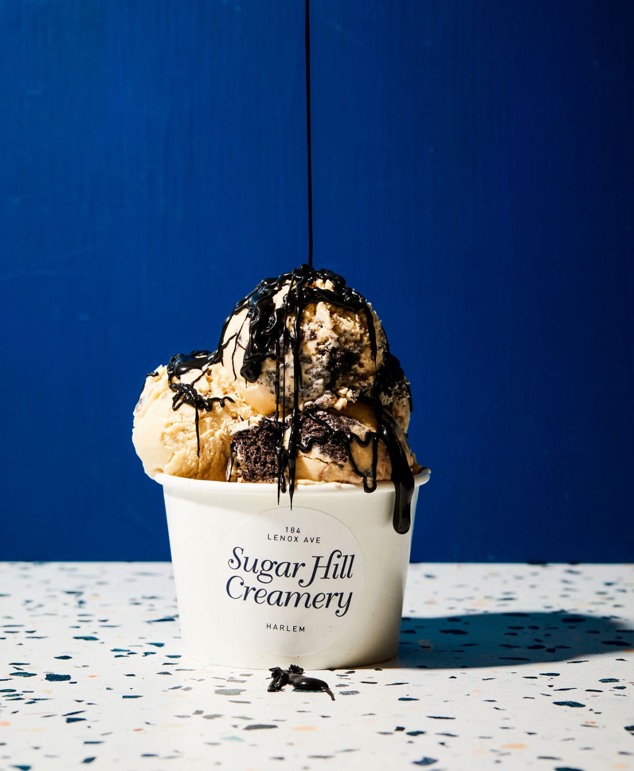 Chocolate syrup poured on top of ice cream.