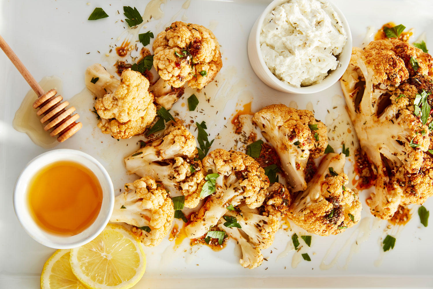 A tray of roasted cauliflower drizzled in honey.