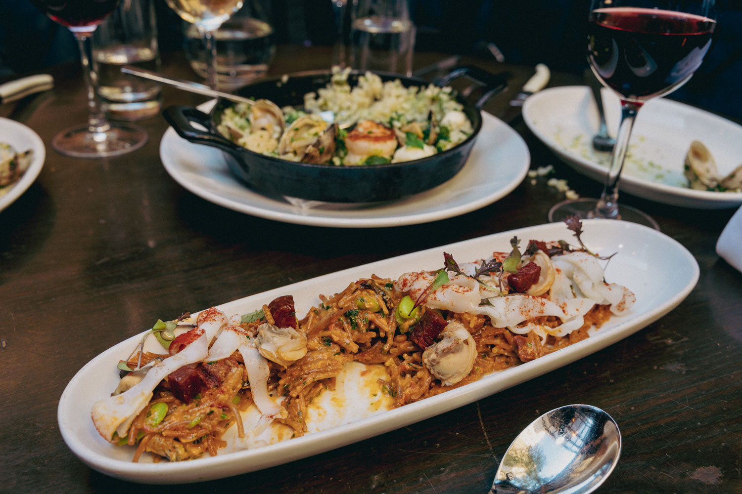 Two dishes served on a dining room table.