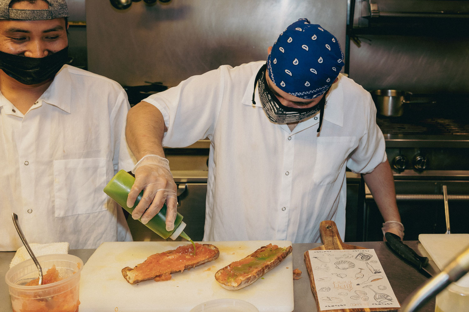 A chef dressing a meal.