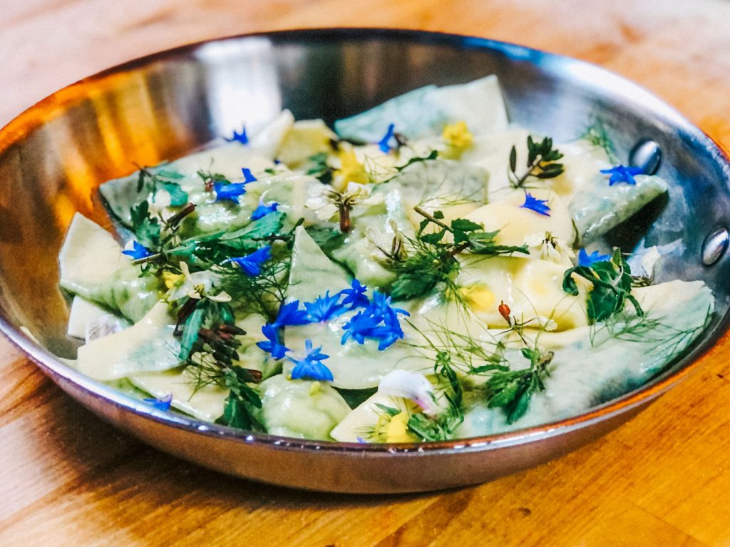 A dish topped with fresh, edible flowers.