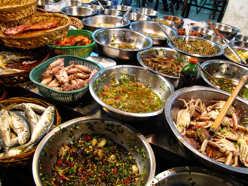 Stainless steel bowls filled with a variety of Teochew food.
