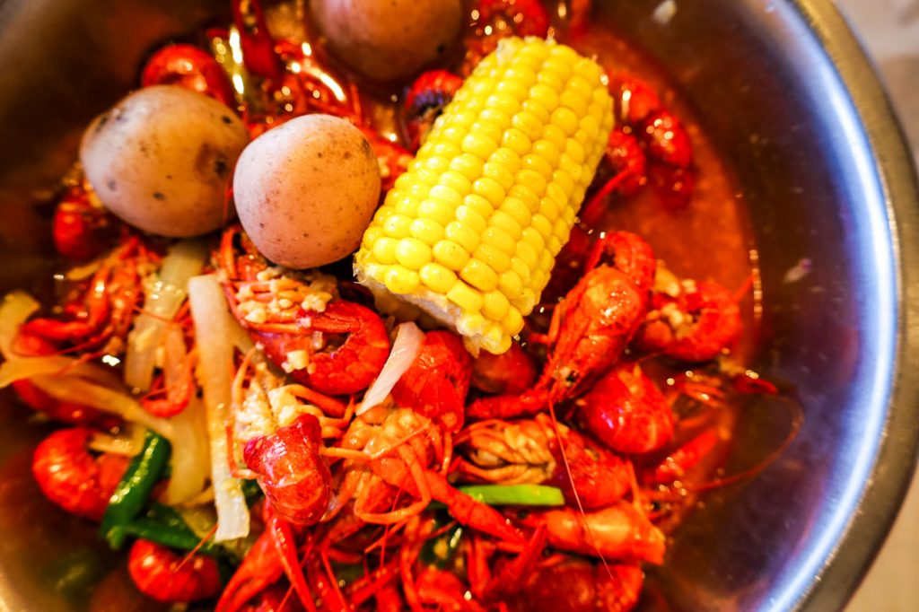 A crawfish boil with corn and potatoes.