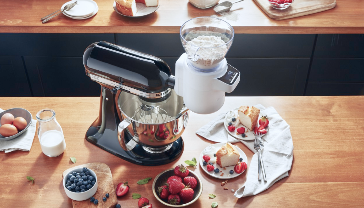 A KitchenAid® stand mixer mixing flour and other ingredients.