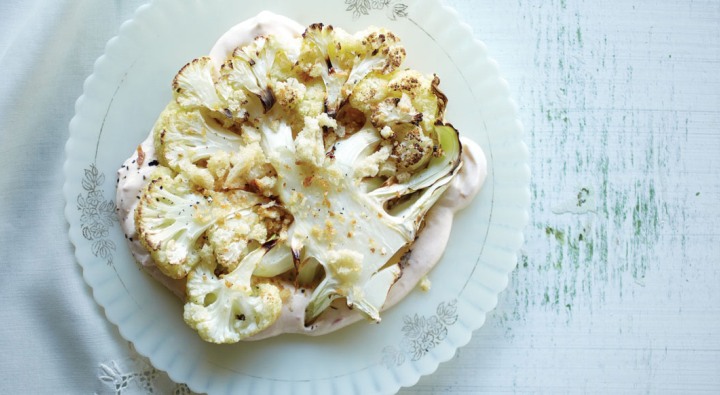Cooked cauliflower on a serving dish. Cooked cauliflower on a serving dish.