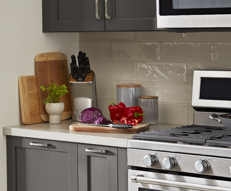 Countertop prep space with wooden cutting boards and a knife block