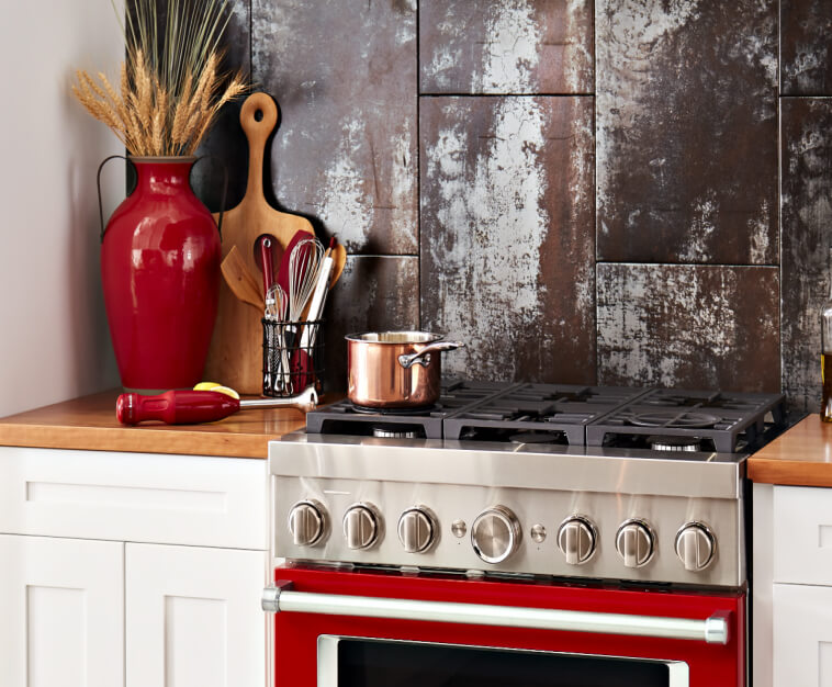 Cooking utensils beside a pot on the rangetop