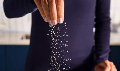 A person sprinkling salt.