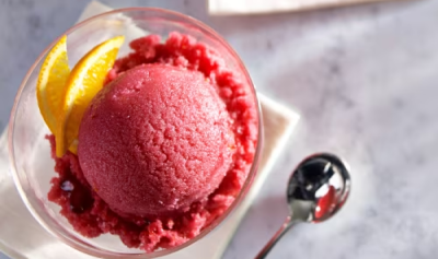 A bold pink sorbet in a glass bowl.