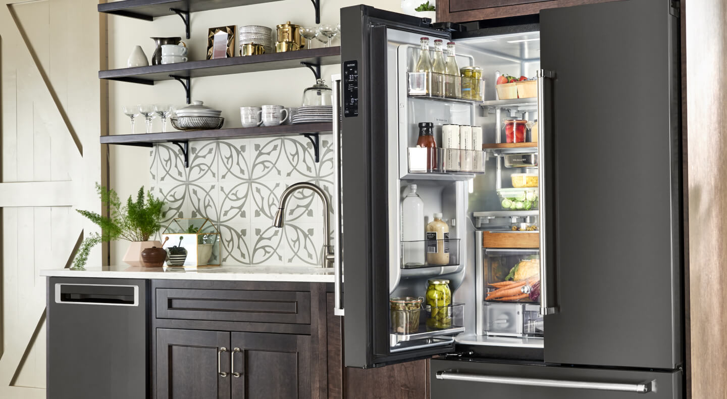A kitchen with an open refrigerator in it