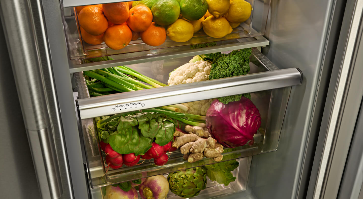 A closeup of refrigerator shelves with vegetables on them