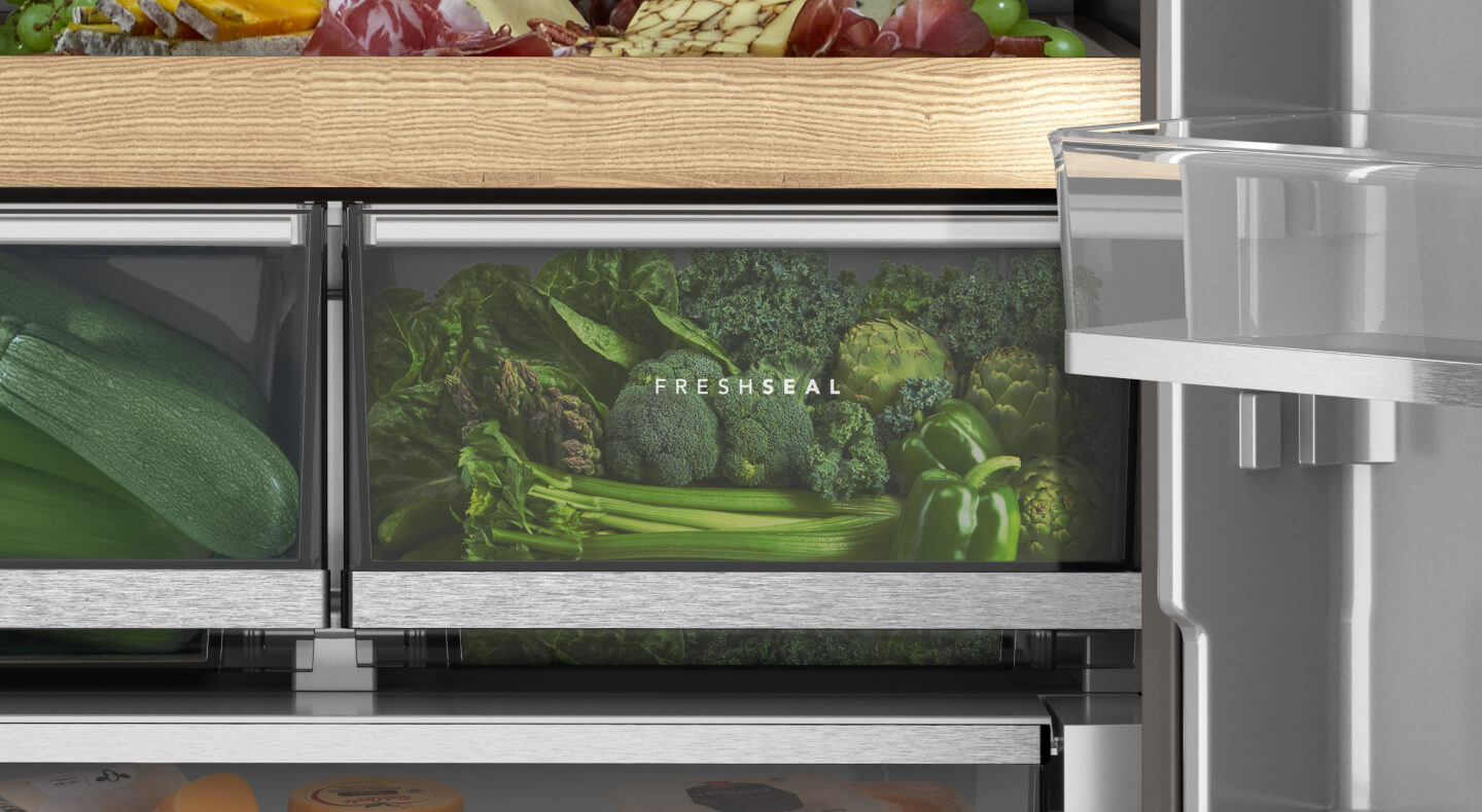 A closeup of refrigerator drawers with green vegetables in them