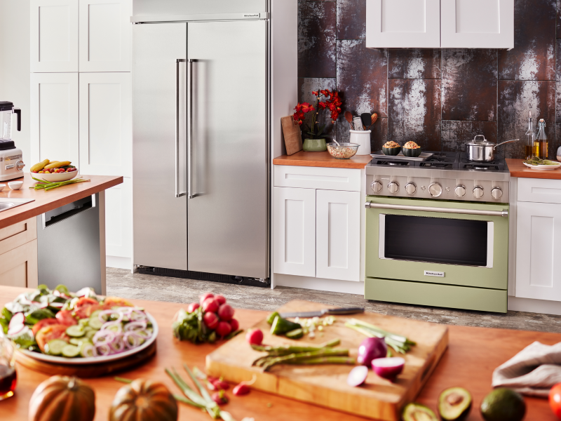 Olive green KitchenAid® gas range in white cabinetry with a rustic backsplash Olive green KitchenAid® gas range in white cabinetry with a rustic backsplash