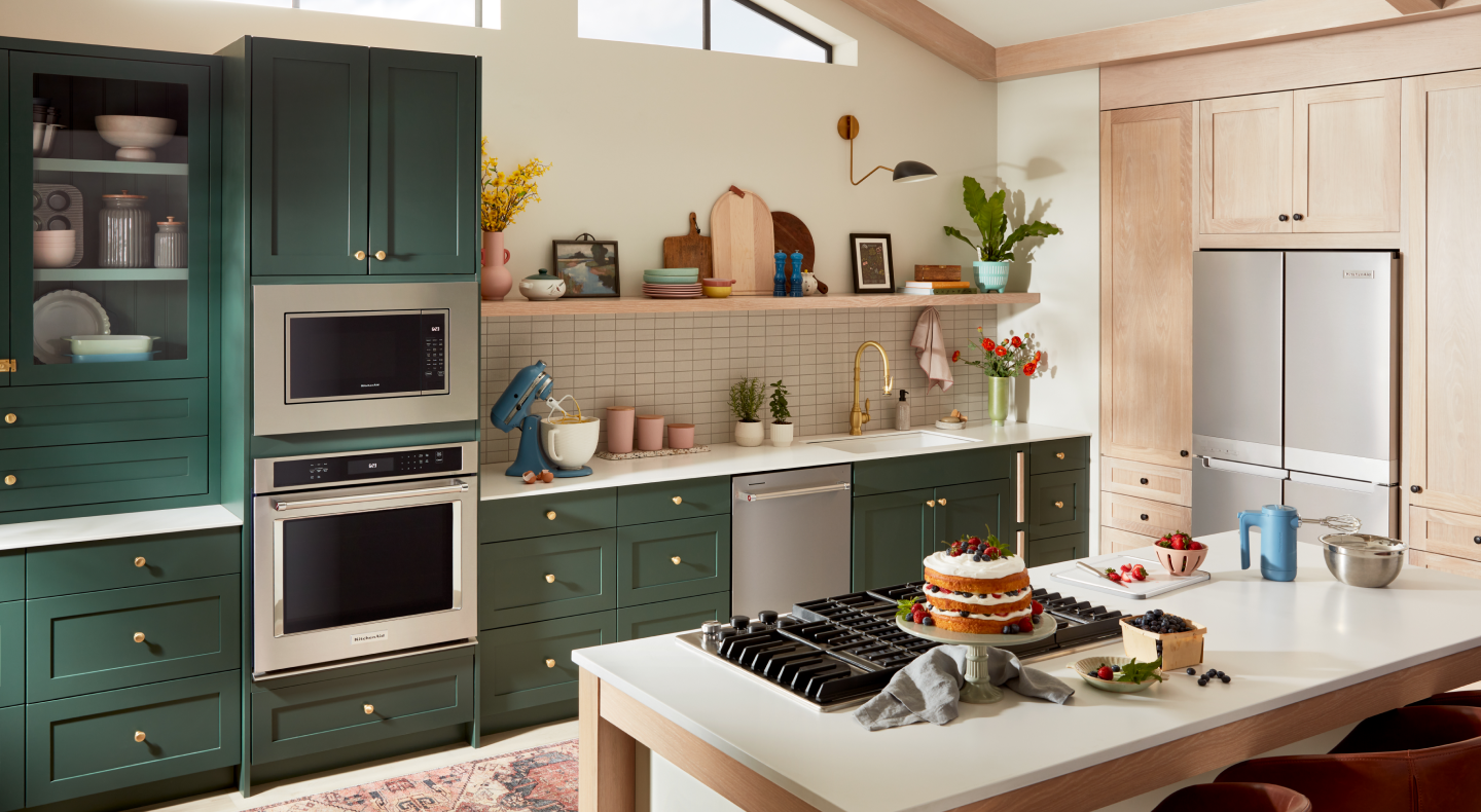 Single KitchenAid® wall oven beneath a built-in microwave next to a blue KitchenAid® stand mixer on counter