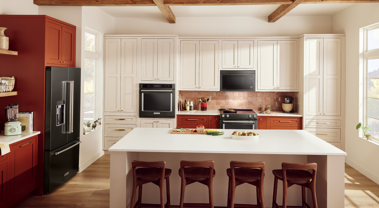 Black stainless KitchenAid® single wall oven, over-the-range microwave and French-door refrigerator in an open kitchen