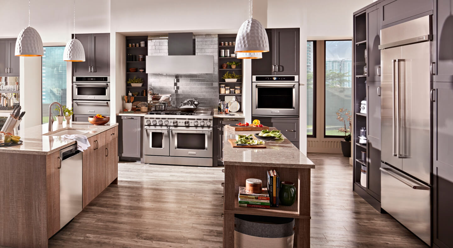 KitchenAid® stainless steel appliances in an open kitchen with two islands