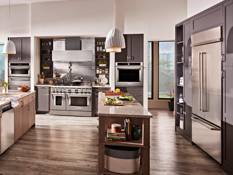 KitchenAid® stainless steel appliances in an open kitchen with two islands