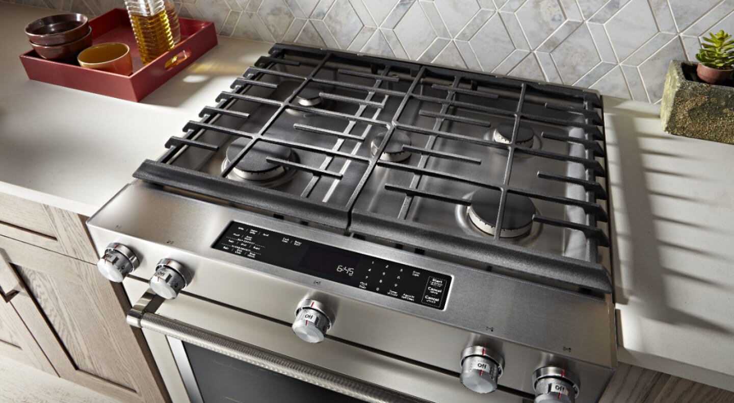 KitchenAid® gas range installed between white countertops
