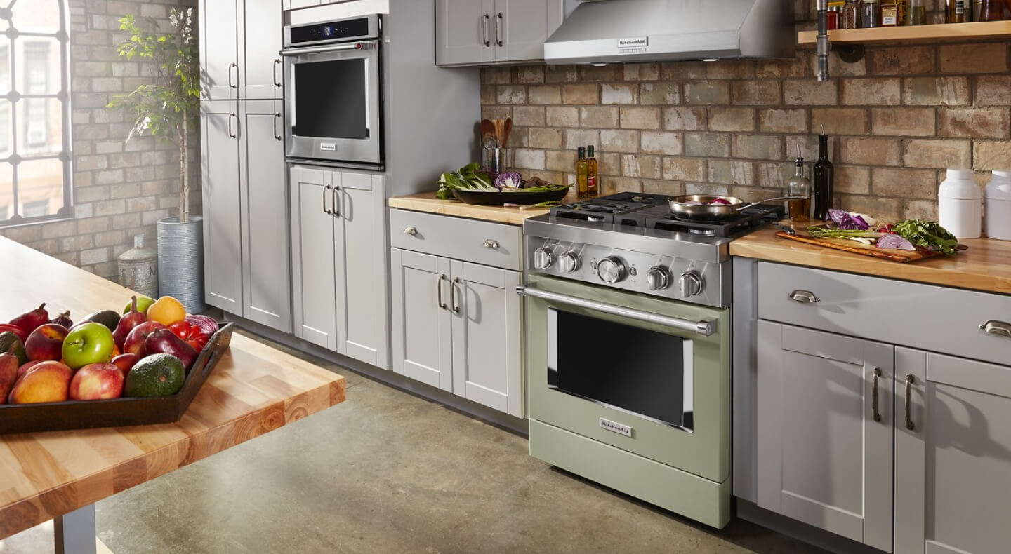 Colorful KitchenAid® commercial-style range in pale blue cabinetry