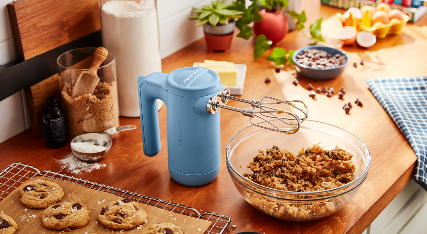 KitchenAid® Hand Mixer mixing a bowl of oatmeal raisin cookie ingredients