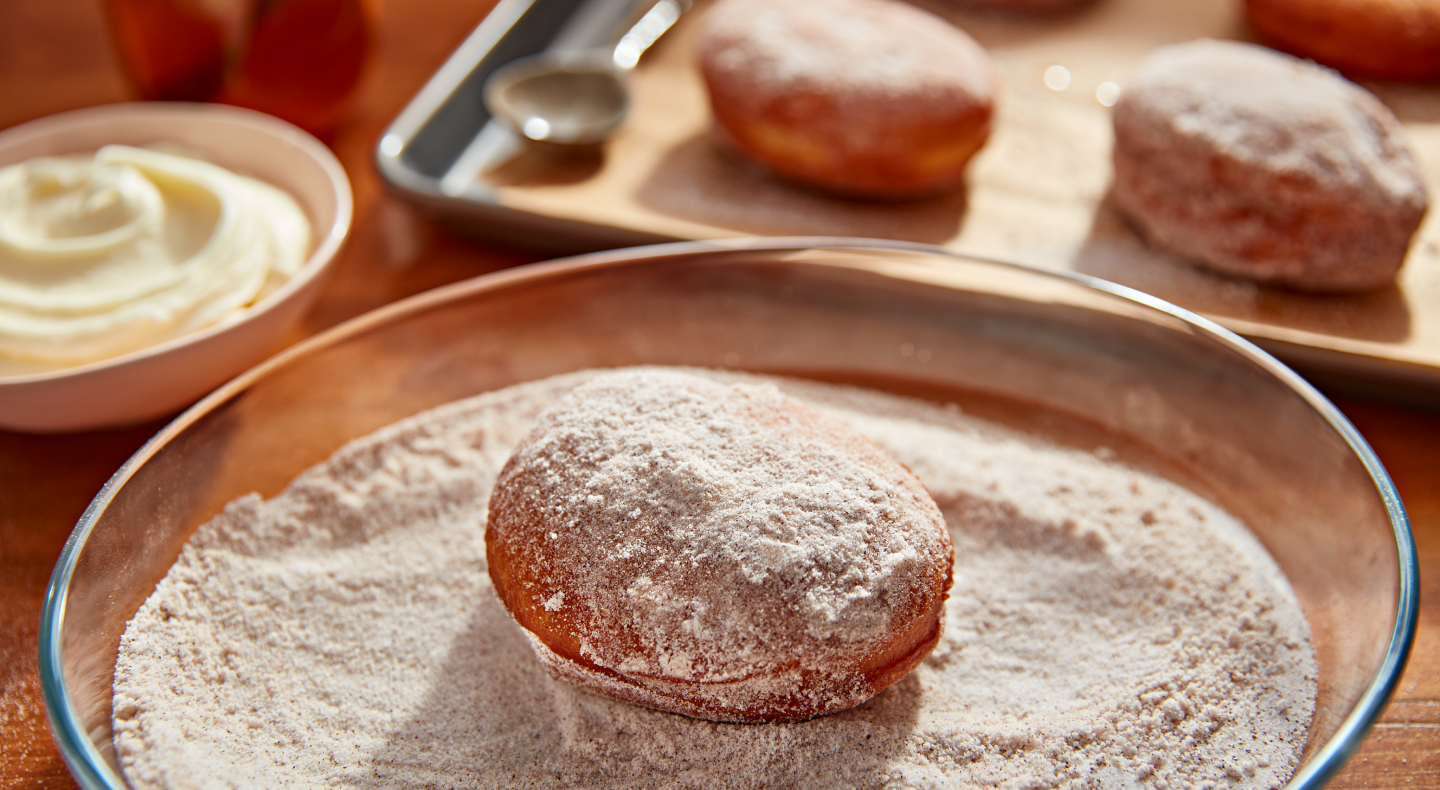 Donut in a bowl of light and dark brown sugar Donut in a bowl of light and dark brown sugar