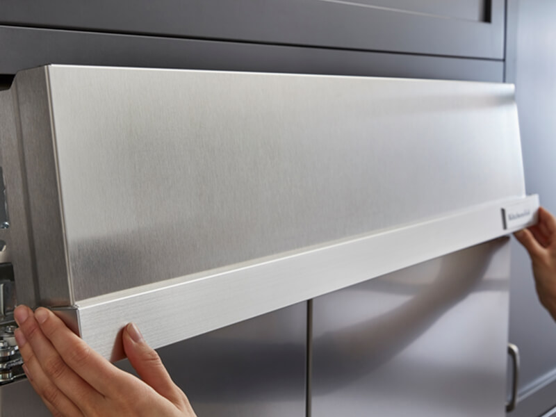 Hands installing parts of a KitchenAid® refrigerator Hands installing parts of a KitchenAid® refrigerator