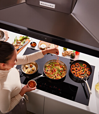 Person cooking on an electric cooktop