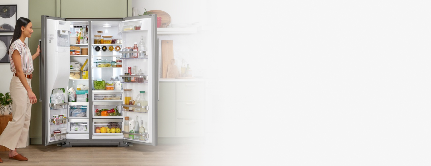 Side-by-side refrigerator filled with fresh and frozen food