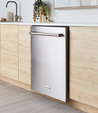 A built-in KitchenAid® dishwasher in a kitchen with light cabinets