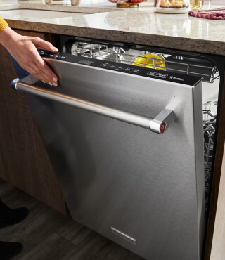 Person opening a top control dishwasher