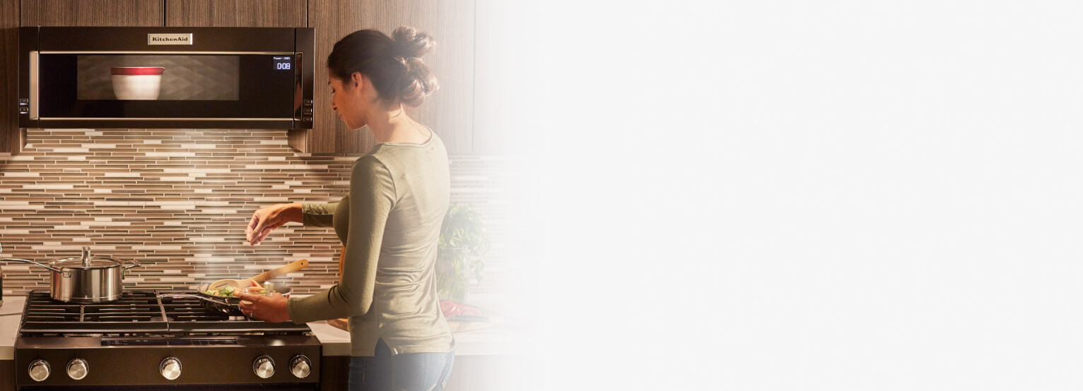 Person cooking on a gas range cooktop