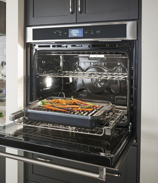 Wall oven open with food in it