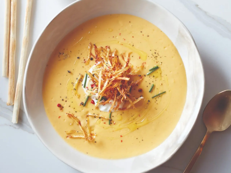 Potato cream soup in white bowl