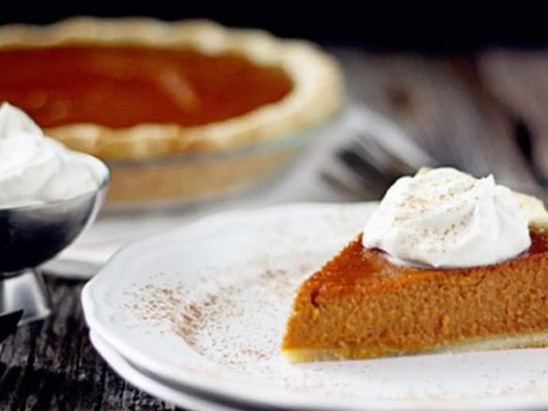 Slice of sweet potato pie on white plate