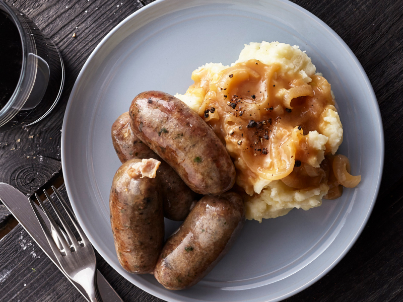 Sausage and mashed potatoes covered with gravy Sausage and mashed potatoes covered with gravy