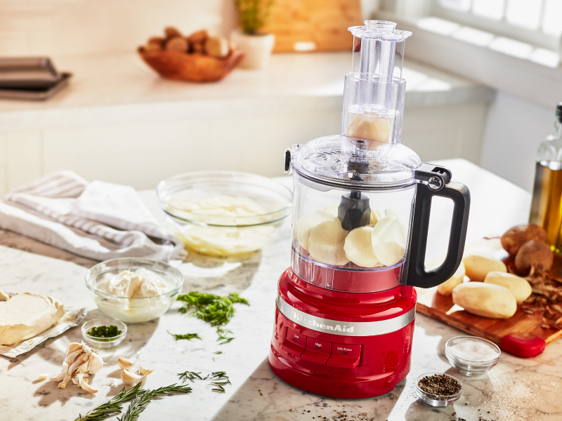 Potatoes in food processor surrounded by ingredients Potatoes in food processor surrounded by ingredients