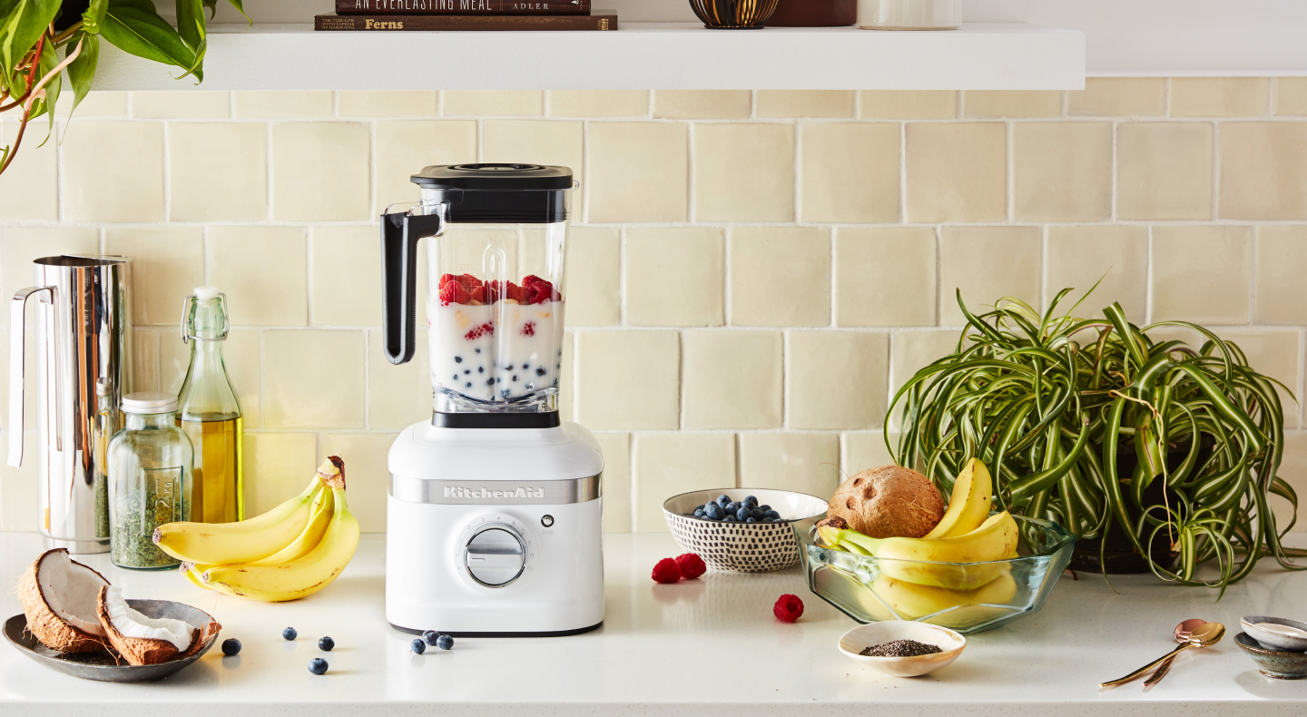 White KitchenAid® blender filled with milk and mixed berries White KitchenAid® blender filled with milk and mixed berries