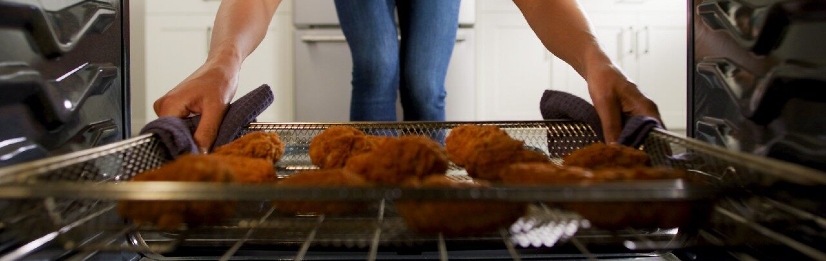 Person pulling food out of an oven