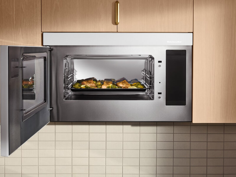 Fish and broccoli on tray inside a KitchenAid® microwave with the door open Fish and broccoli on tray inside a KitchenAid® microwave with the door open