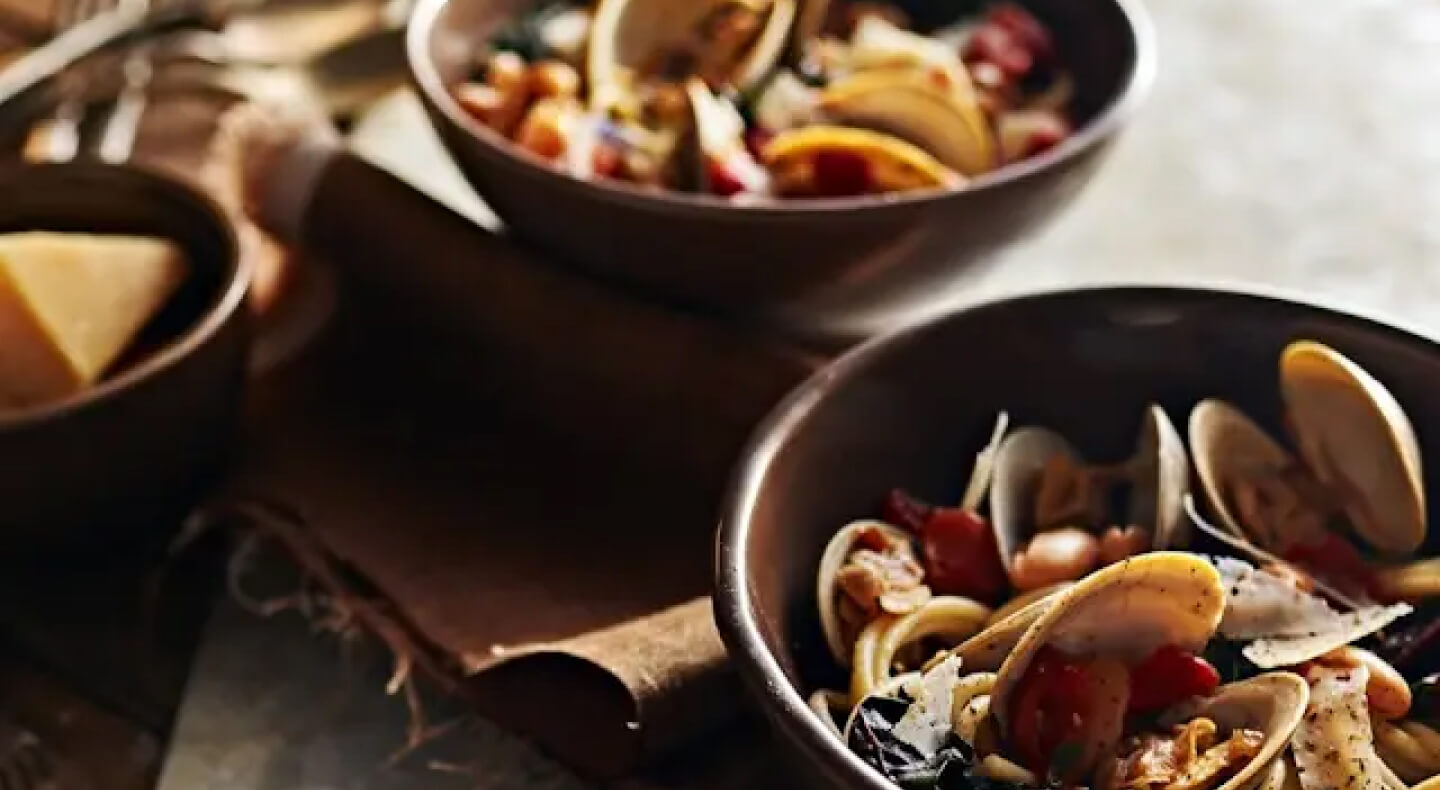 Bowls of steamed clams with beans and greens Bowls of steamed clams with beans and greens