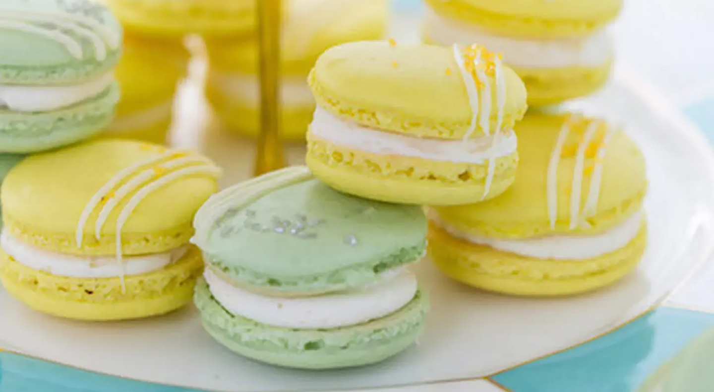 A plate of lemon and lime macarons. A plate of lemon and lime macarons.