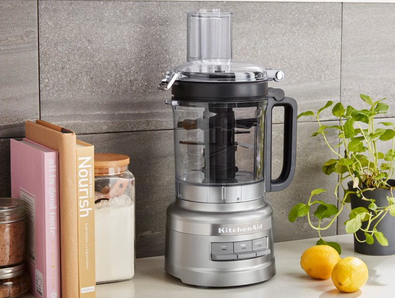 A KitchenAid® food processor on a modern kitchen counter. A KitchenAid® food processor on a modern kitchen counter.