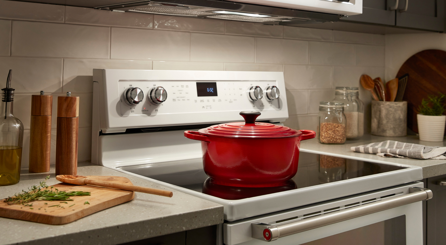 A red pot on a white slide-in range A red pot on a white slide-in range