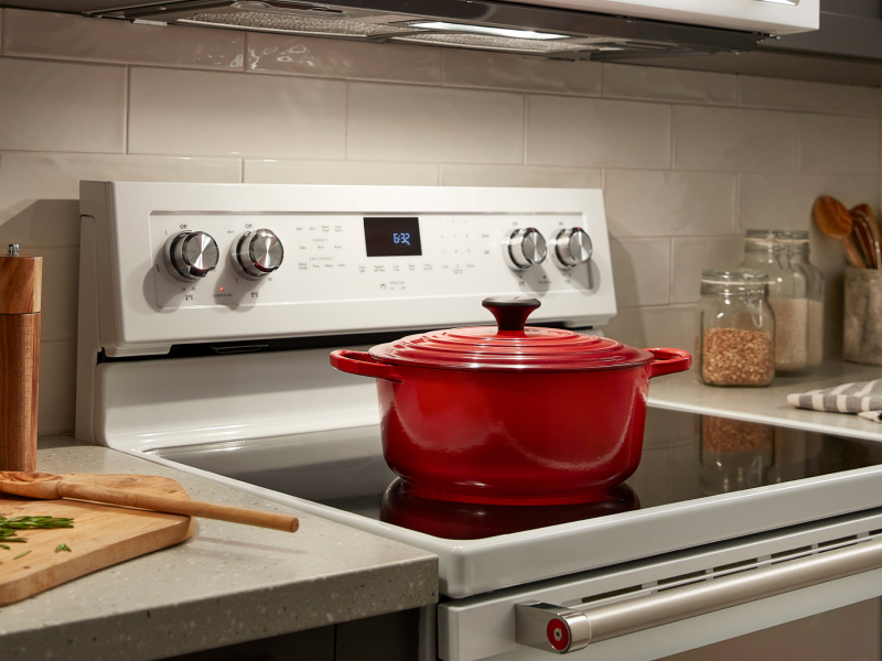 A red pot on a white slide-in range A red pot on a white slide-in range