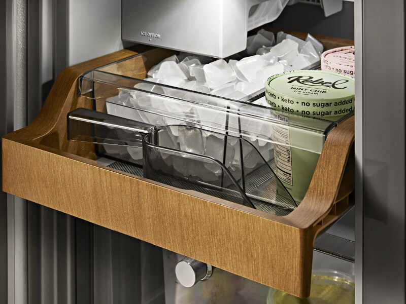 Ice and ice cream inside a wood-paneled ice compartment Ice and ice cream inside a wood-paneled ice compartment