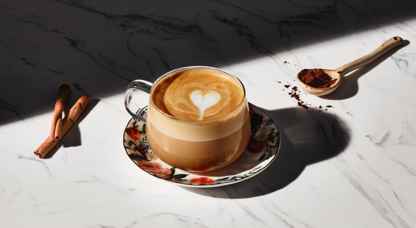 Latte with a steamed milk heart in a glass mug Latte with a steamed milk heart in a glass mug