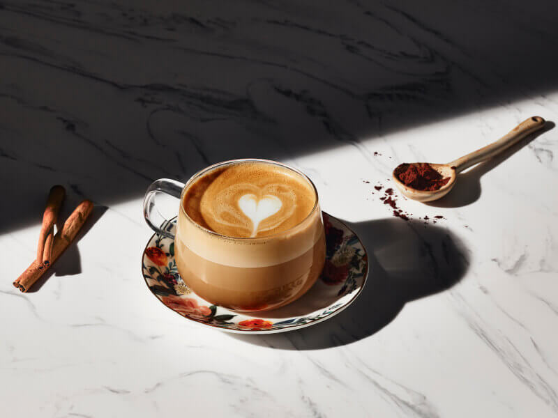Latte with a steamed milk heart in a glass mug Latte with a steamed milk heart in a glass mug