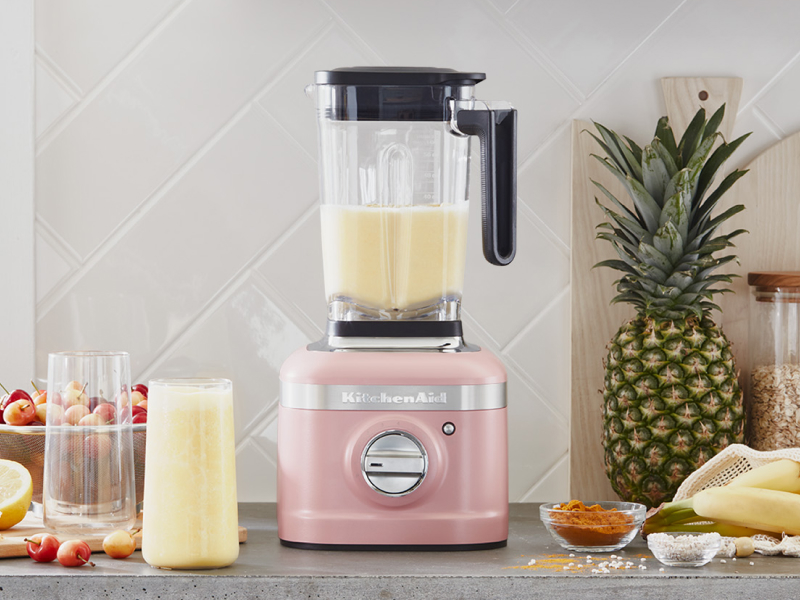 A KitchenAid® blender with a freshly made smoothie on a modern kitchen counter. A KitchenAid® blender with a freshly made smoothie on a modern kitchen counter.
