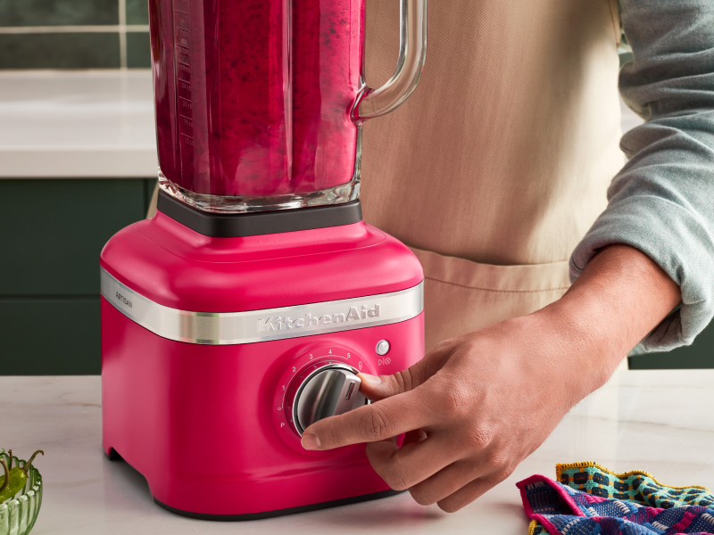 A person programming a blender setting on a KitchenAid® blender. A person programming a blender setting on a KitchenAid® blender.