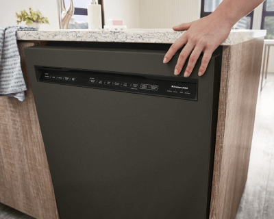 KitchenAid® front control dishwasher with pocket handle built into an island
